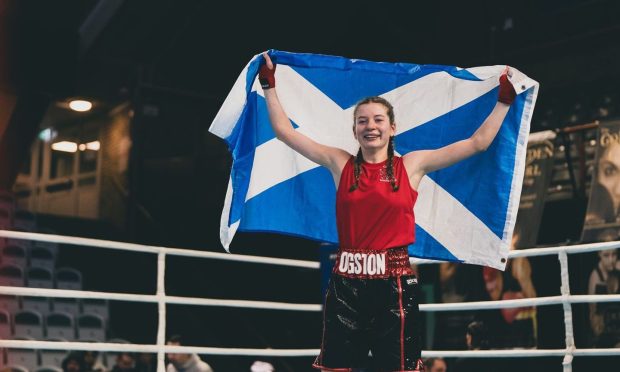 CAIN boxing club's Darya Ogston holds aloft the Scotland flag after winning gold in Sweden