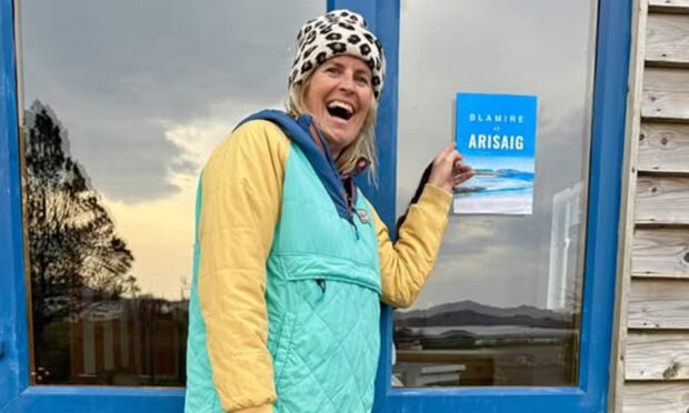 Hope Blamire outside the door of her new shop in Arisaig.