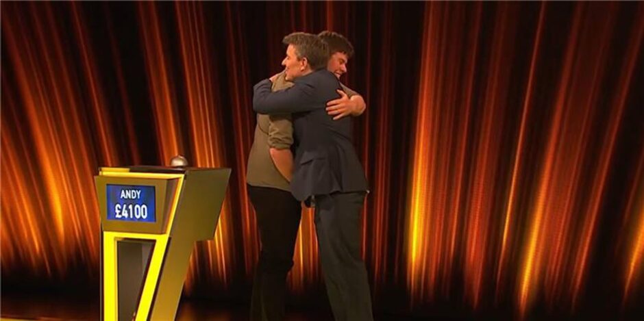 Andy hugs with presenter Ben