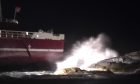 Cargo hitting waves and rocks