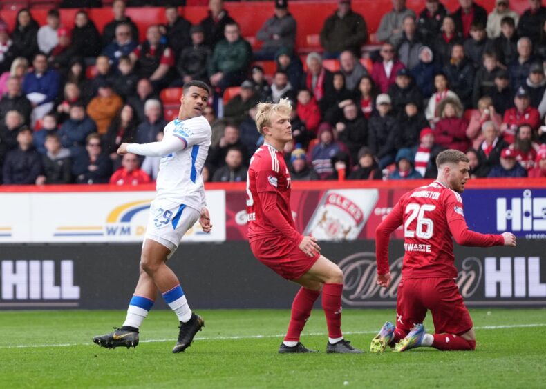 Hamza Igamane of Rangers scores to reduce Aberdeen's lead to 2-1, with Alexander Jensen and Alfie Dorrington of Aberdeen, right. Image: Shutterstock.