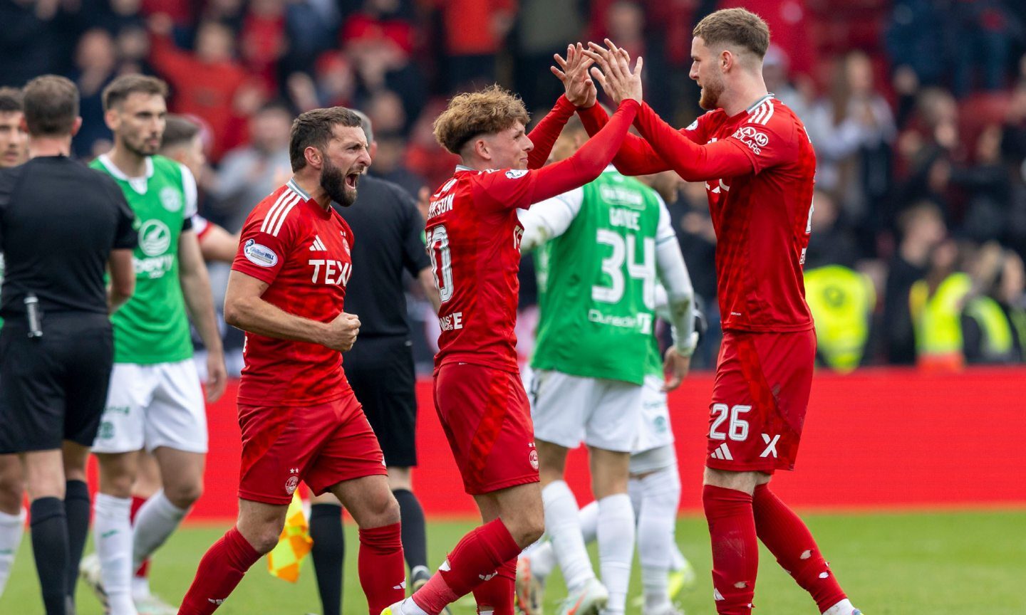 Aberdeen's Graeme Shinnie (left)celebrates with Leighton Clarkson (centre) and Alfie Dorrington after the 1-0 win against Hibs. Image - Shutterstock