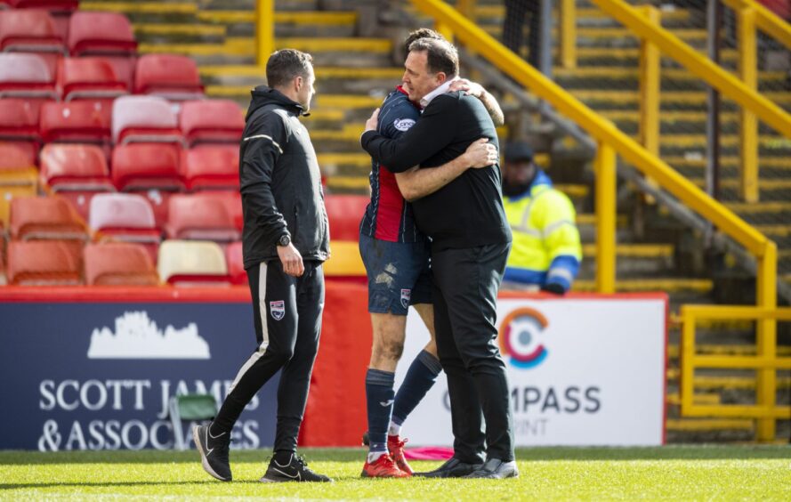 Malky Mackay celebrates with Jack Baldwin and then Ross County assistant Don Cowie after clinching a top-six place in 2022. 