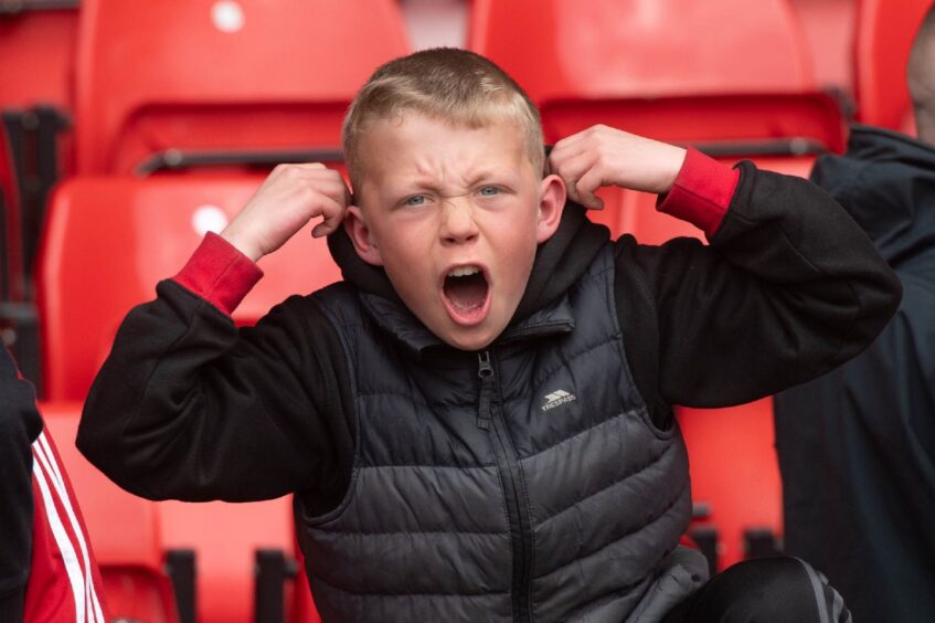 A young Dons fan celebrates his side's win over Hearts in the Scottish Cup semi-final. Image: Darrell Benns/DC Thomson