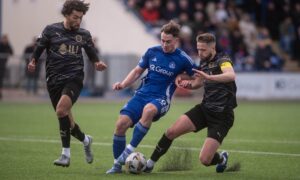 Cove's Myles Gaffney being challenged by Caley Thistle captain Danny Devine. Image: Darrell Benns/DC Thomson