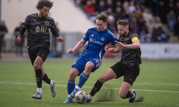 Cove's Myles Gaffney being challenged by Caley Thistle captain Danny Devine. Image: Darrell Benns/DC Thomson