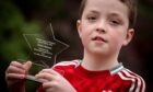 10-year-old Fraser Duncan with his Random Acts of Kindness award. Image: Darrell Benns/DC Thomson