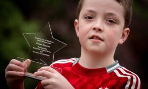 10-year-old Fraser Duncan with his Random Acts of Kindness award. Image: Darrell Benns/DC Thomson