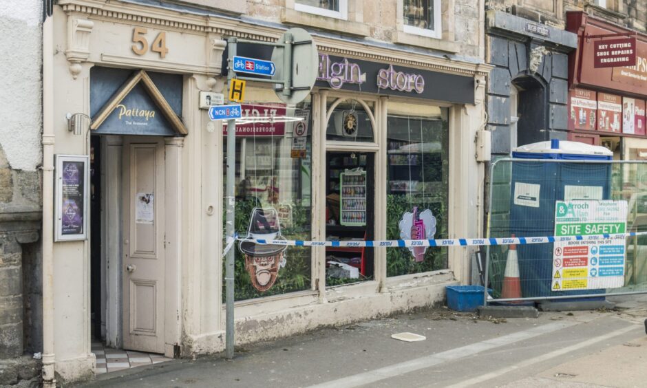 Police tape outside the windows of Elgin Store.