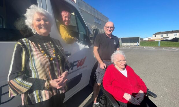 Elsie Normington, Fiona MacInnes, Martin Pieraccini and  Anne McCreadie (seated) with the new bus. Image: Partnership for Wellbeing