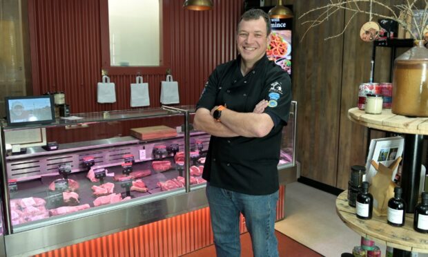 Jock Gibson standing at butcher counter.