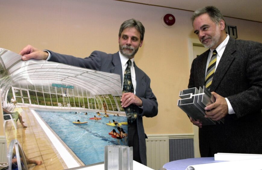 Douglas Samways holding a picture of a swimming pool while standing next to Peter Michaels 