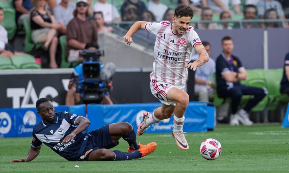 Adama Traoré of Melbourne Victory FC and Nicolas Milanovic of Western Sydney Wanderers in action. Image: Shutterstock.