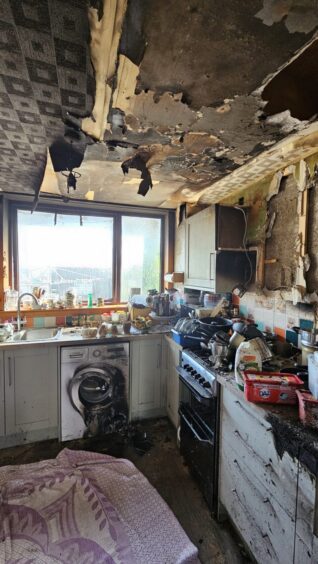 Picture showing damage to the ceiling and worktops in the kitchen.