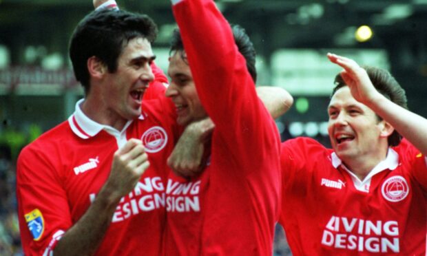 Mike Newell (left) and Billy Dodds congratulate Stephen Glass (centre) after he scored against Rangers.