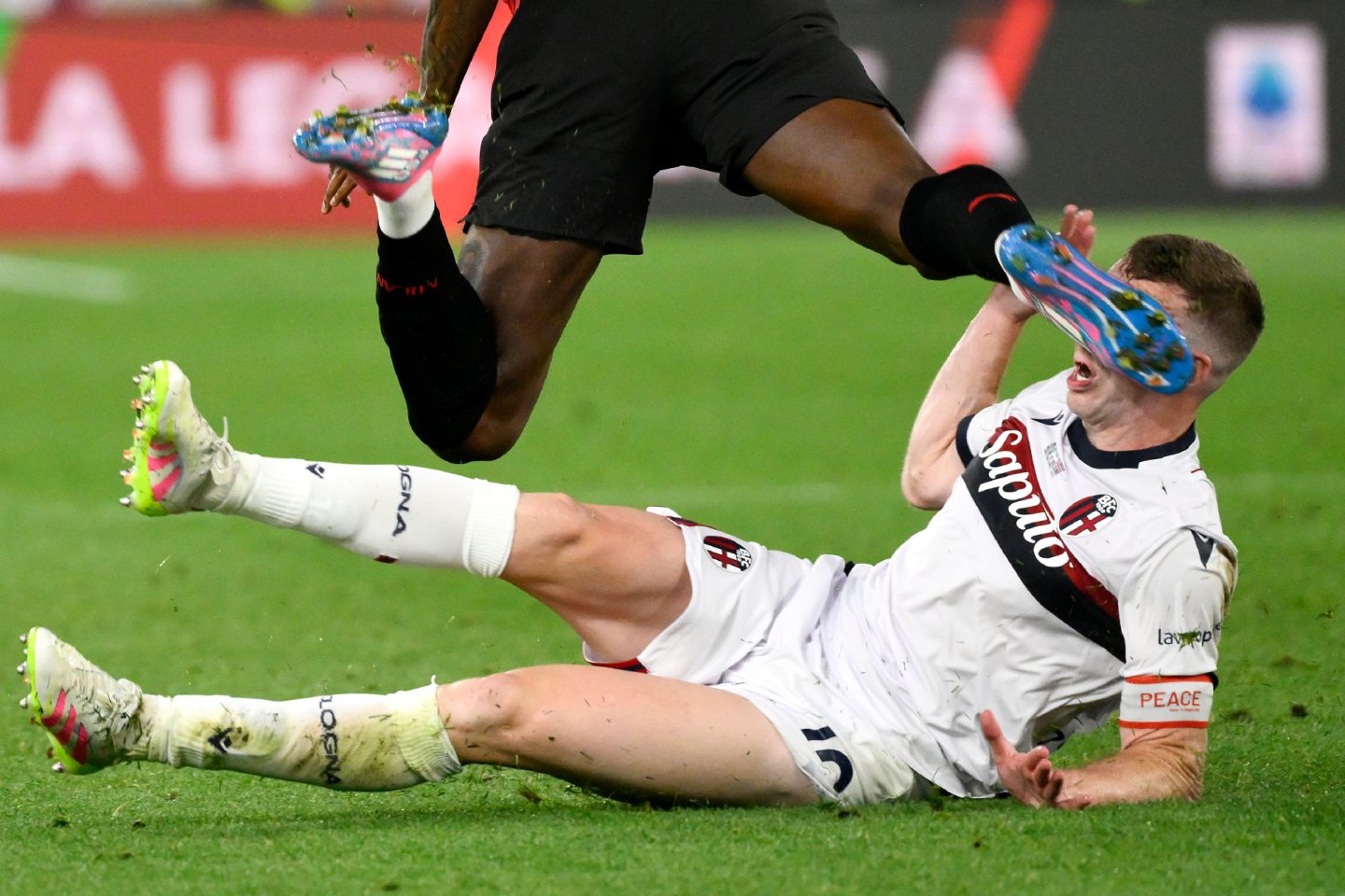 Lewis Ferguson is accidentally kicked in the face by Rafael Leao of AC Milan in the Coppa Italia final. 