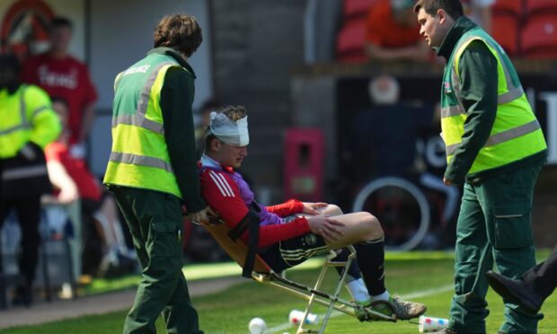 Aberdeen Jack MacKenzie was left with a head wound after the incident at Tannadice. Image: Pete Summers/Shutterstock