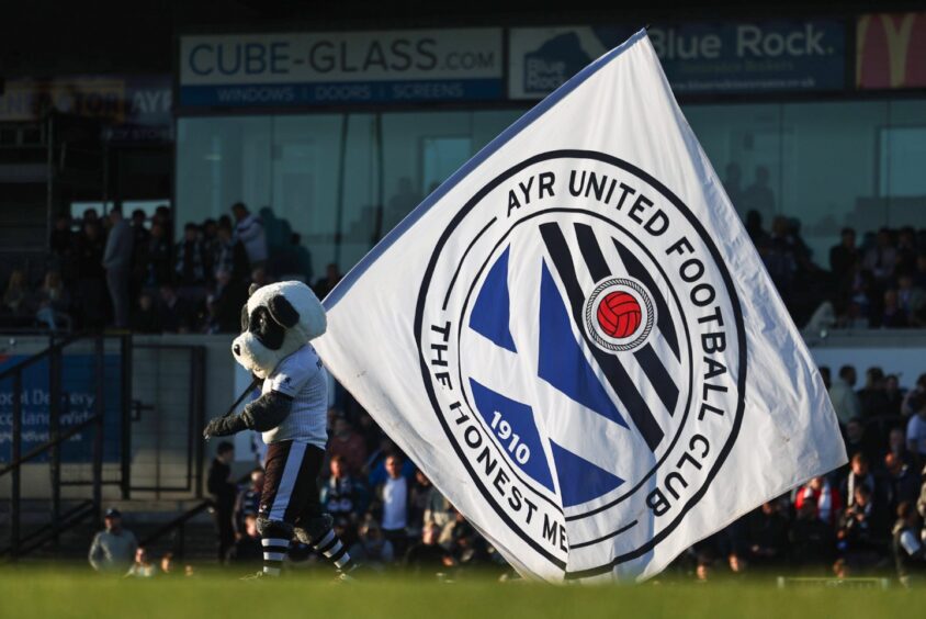 Ayr United's mascot Pandamonium with an Ayr United flag before the Premiership play-off quarter-final against Partick Thistle at Somerset Park, Ayr, on May 9, 2025. 