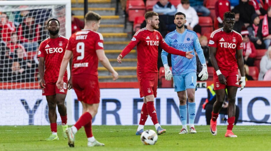 Aberdeen's Alfie Dorrington and Dimitar Mitov look dejected during the 5-1 Premiership loss to Celtic at Pittodrie.