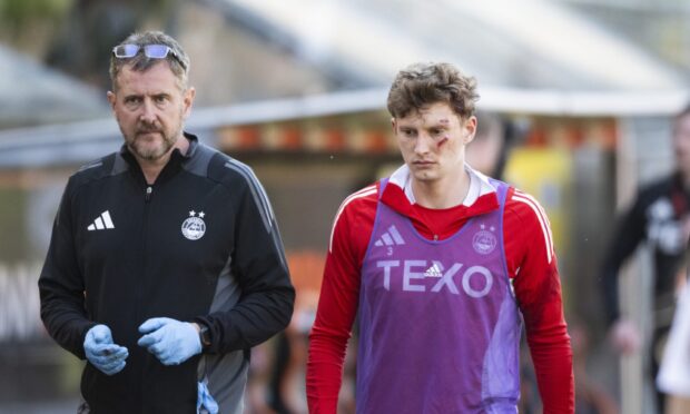 Aberdeen's Jack MacKenzie (R) after he was struck by an object thrown from the crowd during the William Hill Premiership match between Dundee United and Aberdeen at the CalForth Construction Arena at Tannadice Park, on May 17, 2025. Image: SNS.