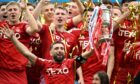 Aberdeen captain Graeme Shinnie lifts the Scottish Cup at Hampden after a dramatic penalty shoot-out win against Celtic. Image: SNS
