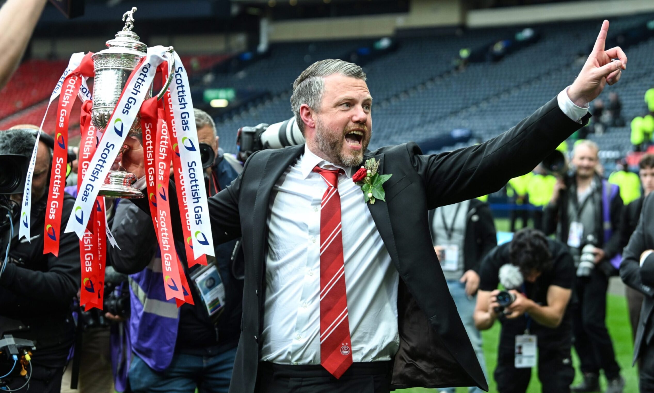 Aberdeen manager Jimmy Thelin with the Scottish Cup trophy at Hampden after winning on penalties against Celtic in the final.