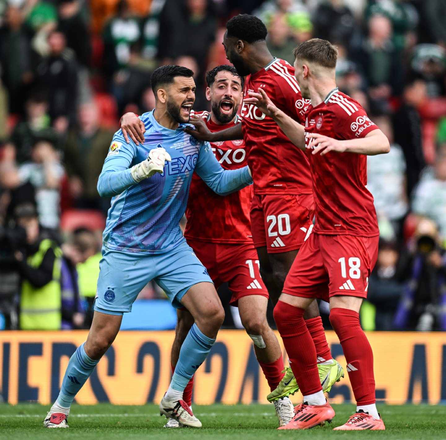The Aberdeen players celebrate with Dimitar Mitov. Image: SNS.