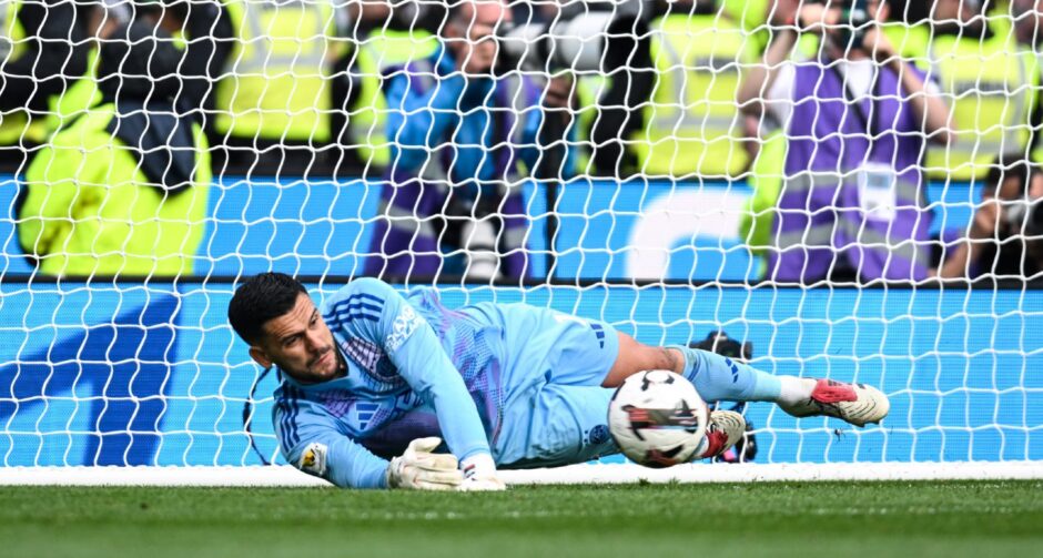 Aberdeen's Dimitar Mitov makes a save in the penalty shootout. Image: SNS