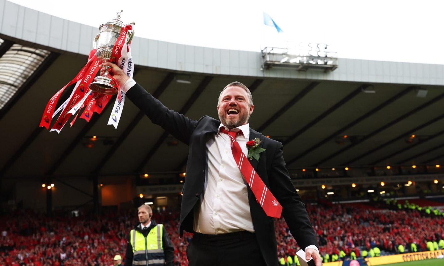 Aberdeen manager Jimmy Thelin celebrates with the Scottish Cup at Hampden after the final win against Celtic.