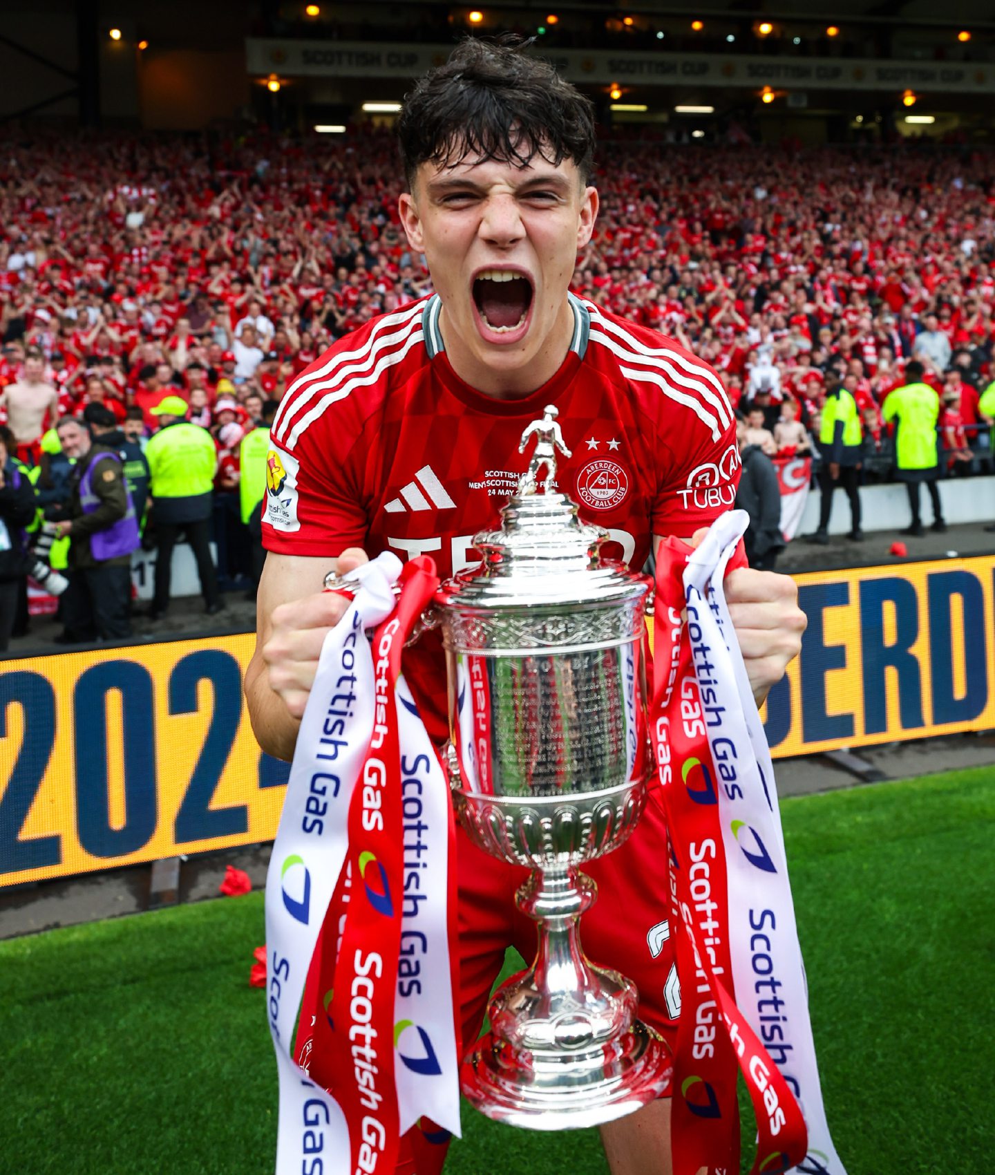 Aberdeen's Jack Milne with the Scottish Cup trophy after the final win against Celtic at Hampden.