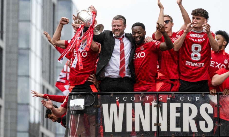 Aberdeen manager Jimmy Thelin and Shayden Morris are pictured leading the celebrations during the Aberdeen bus parade to celebrate winning the Scottish Cup.