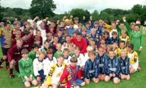 The under-12s Soccer Sevens team get together with Dons stars Darren Young, Malcolm Kpedekpo and Aberdeen FC community coach Chic McLelland to celebrate a successful 1997 Aberdeen International Football Festival tournament at Seaton Park. Image: DC Thomson Archives.
