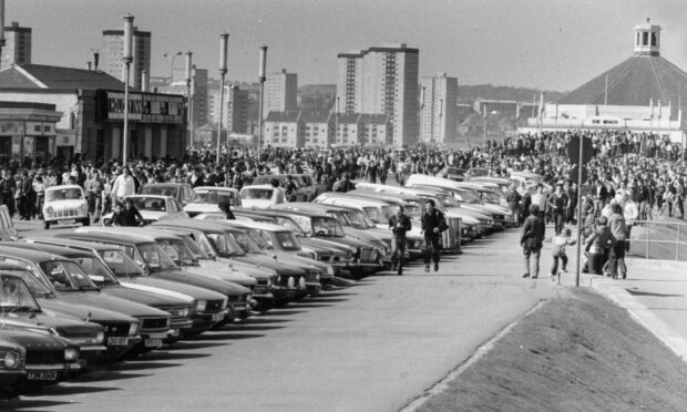 1980: Holiday traffic ground to a virtual standstill at Aberdeen Beach as thousands of people enjoyed the Lions Club fayre at Queen's Links. Crowds of holidaymakers, sweltering in the blazing sunshine on the May Day break, could only look on as the hordes of youths paraded down the prom tailed by the police. Image: DC Thomson