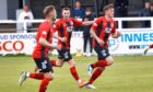 Elgin`s second goalscorer Jack Murray leads the players back after scoring. Image: Bob Crombie
