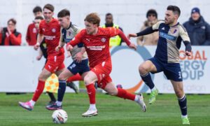 Tony Dingwall of Brora, centre, evades Ian McShane of East Kilbride, right. Pictures by Jasperimage.