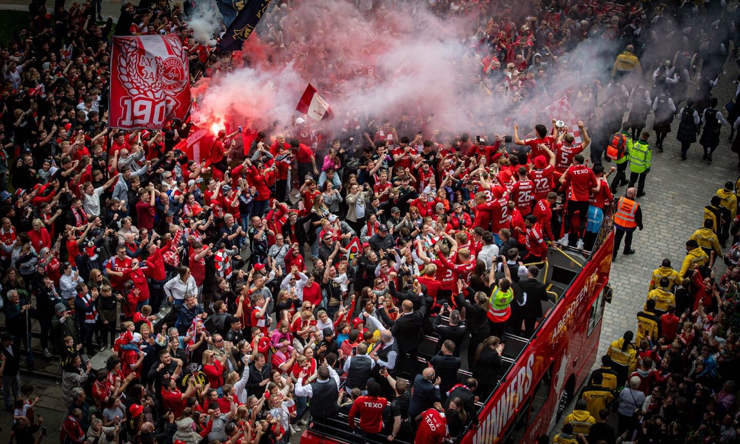 Jubilant scene as fans salute Dons players in the Scottish Cup Final bus parade.
