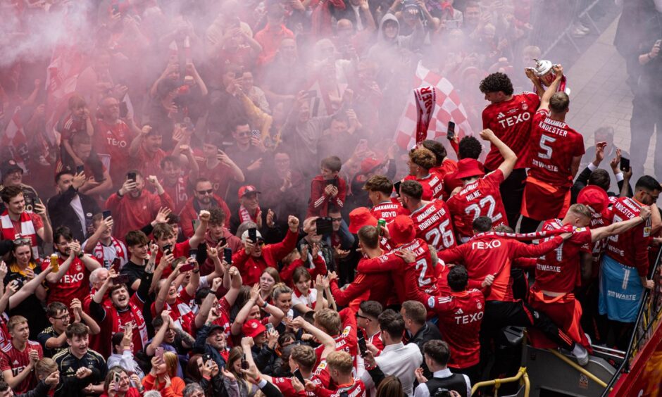 Aberdeen fans celebrate with their heroes on Broad Street. Image: Darrell Benns/DC Thomson.