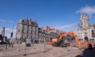 A digger gets to work on the Castlegate.