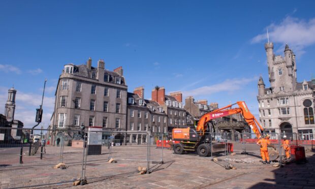 A digger gets to work on the Castlegate.