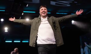 Brave 2025 model Justin Martin works the crowd as he walks the runway. Image: Darrell Benns/DC Thomson