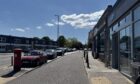 Cars parked on the cobbles on Countesswells Road.