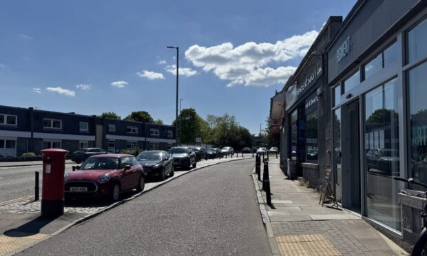 Cars parked on the cobbles on Countesswells Road.