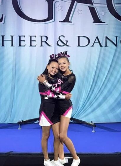 Abbie Main and Emma Whitton cheerleading. 