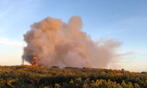Large plume of smoke and flames.