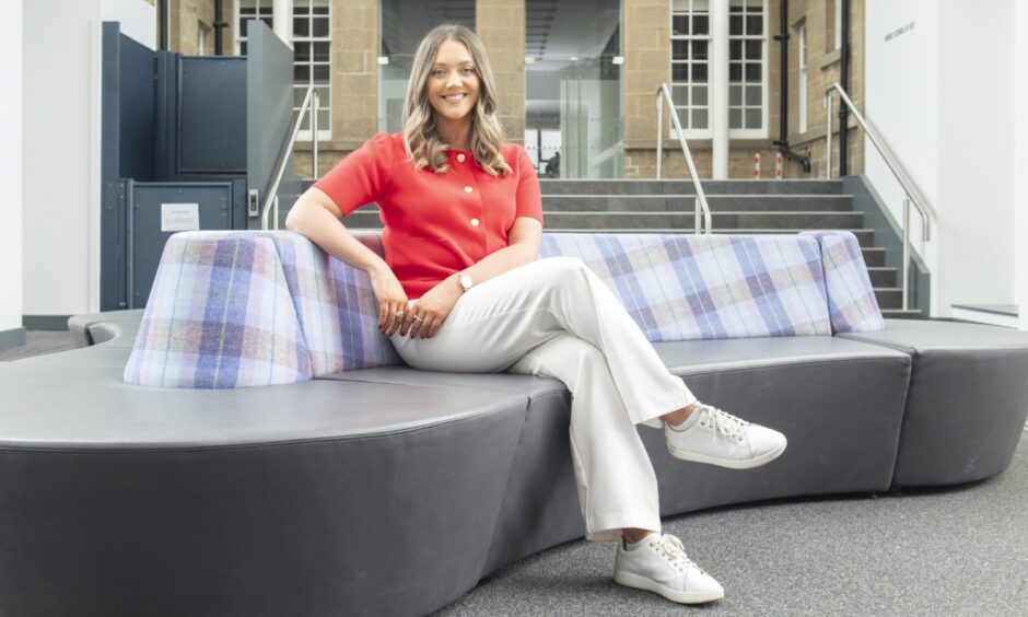 Aimee Stephen sitting in chair. 