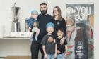 Conor Stewart and his wife Iona with their kids Conor, baby Cash and Cauley Stewart pictured inside the factory. Image: Jason Hedges/DC Thomson