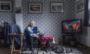 Carol Lawrie with her dog Skye at the home in Torry once her "pride and joy". Picture by Jason Hedges / DC Thomson.