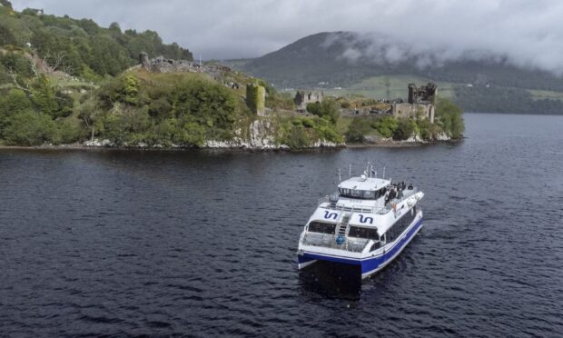Jacobite Cruises boat on Loch Ness by Urquhart Castle.