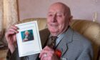 Harold Murray with a copy of his second book about north-east farming life