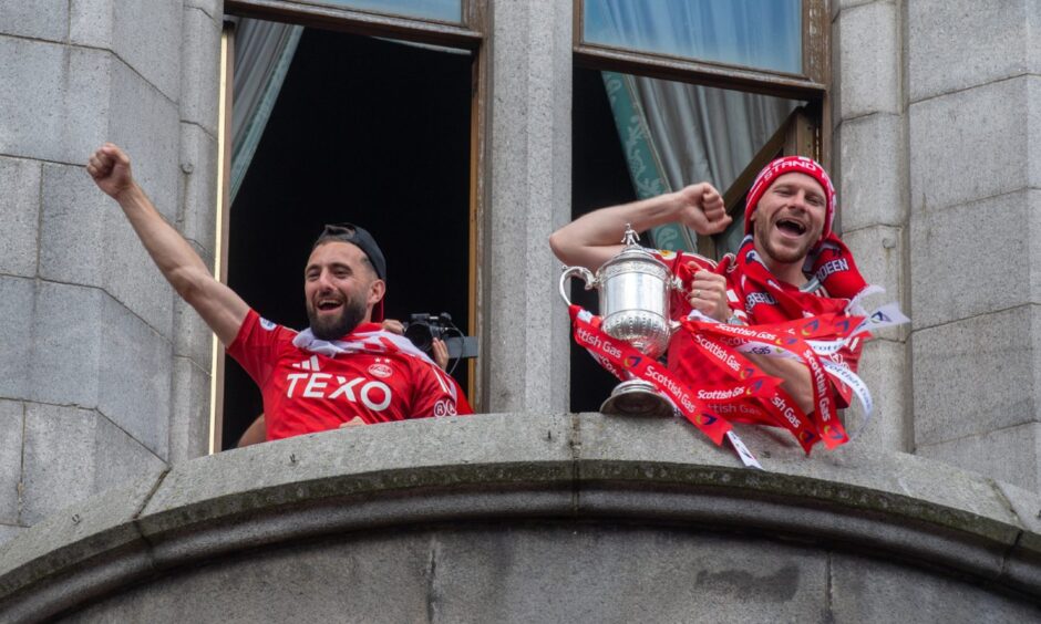 Aberdeen captain Graeme Shinnie, left, and Nicky Devlin on the Townhouse balcony with the Scottish Cup. Image: Kath Flannery/DC Thomson.